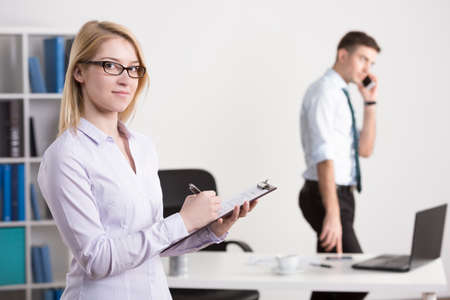 Photo of young pretty female entrepreneur busy at workの写真素材