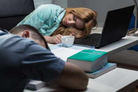 Medical staff exhausted after very long hours of workの写真素材