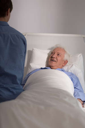 Aged sick man and his grandson's visit at hospitalの写真素材