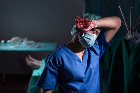 Tired worried surgeon after hard unsuccessful operation