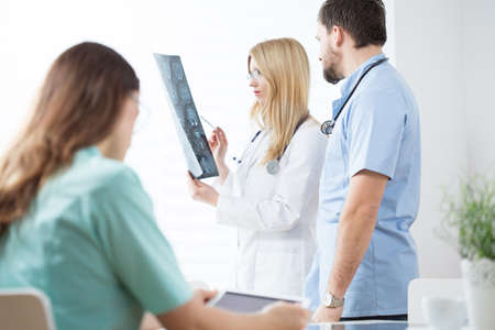 Group of doctors analysing an complicated x-ray