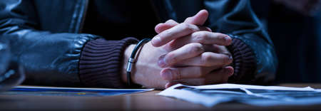 Close-up of the hands of a young man suspected