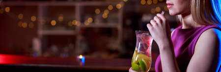 Young girl is drinking delicious coctail in the barの写真素材