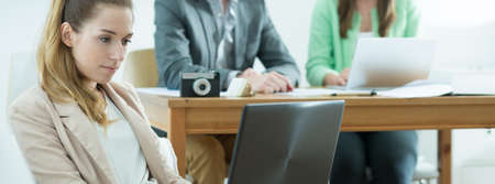 Young woman is working with her teamの写真素材