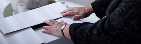 Old widow is packing her dead husband stuffの写真素材