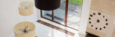 Designed lamp and wall clock in modern interiorの写真素材