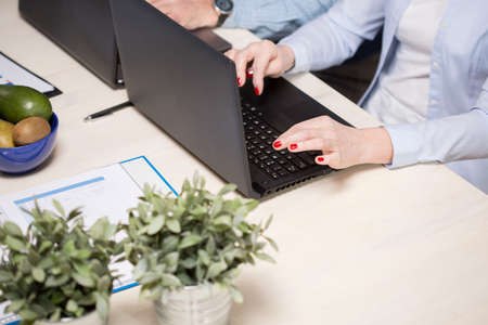 Couple working on their notebooks at the same timeの写真素材