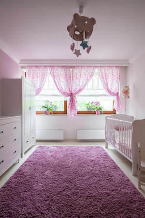 Plush violet carpet in baby girl roomの写真素材