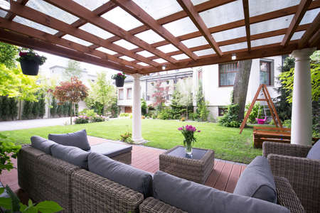 Designed modern arbour with comfortable garden furniture