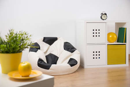 Modern designed room for teenager with football shape armchairの写真素材