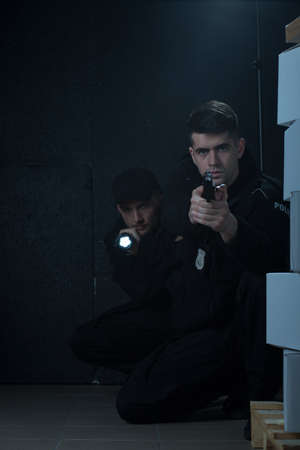 Photo of two policemen working together on intervention
