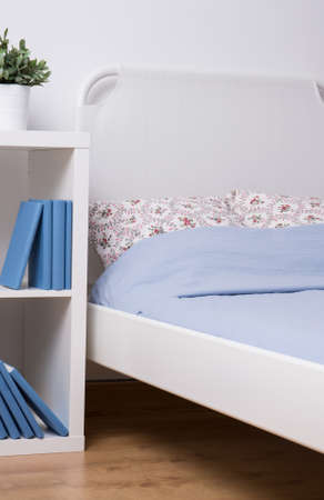 Photo of cozy simple bedroom with wooden floorの写真素材