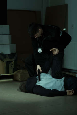 Image of a strong cop overpowering a lawbreaker