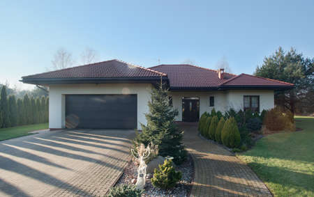 Exterior of detached house with garden on sunny day Exterior of detached house with garden on sunny day