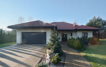 Exterior of detached house with garden on sunny day