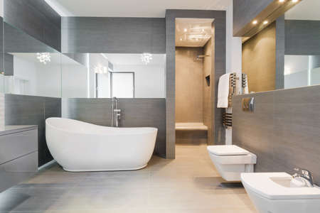 Designed freestanding bath in gray modern bathroom Designed freestanding bath in gray modern bathroom