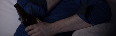 Close-up of bottle of beer in man's handsの写真素材