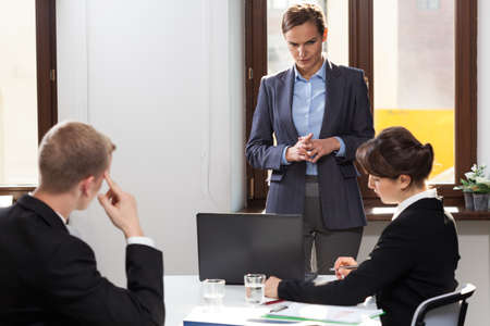 Horizontal view of very serious company meeting