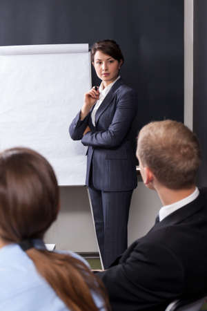 Young pretty woman lecturing during the business meetingの写真素材