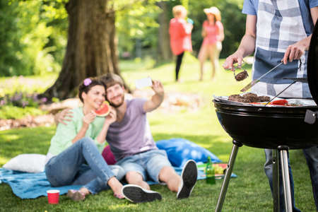 Happy people doing grill in the parkの写真素材