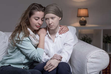 Young sick cancer woman and her supportive friend