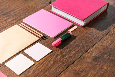 Pink tools prepared on wooden desk office for paperworkの写真素材