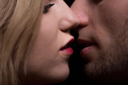 Woman with red lips and man close to kissの写真素材