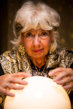 Photo of fortune teller predicting future from crystal ballの写真素材