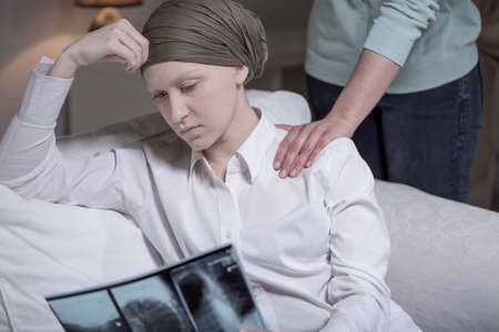 Broken down young cancer woman sitting at home with friend Broken down young cancer woman sitting at home with friend
