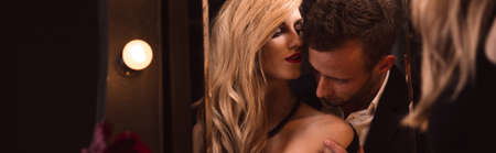 Reflection in the mirror of young woman and manの写真素材