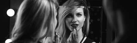 Man is watching woman doing her make-upの写真素材