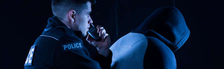 Police officer is reporting that he arrested a banditの写真素材