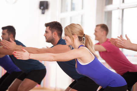 Young happy people during aerobics training, horizontal