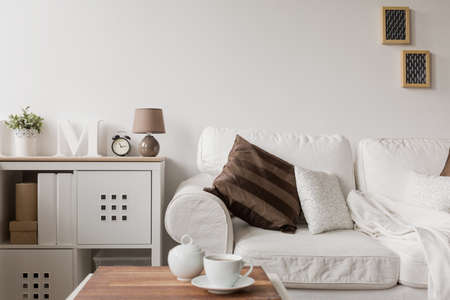 White couch and commode in drawing room White couch and commode in drawing room