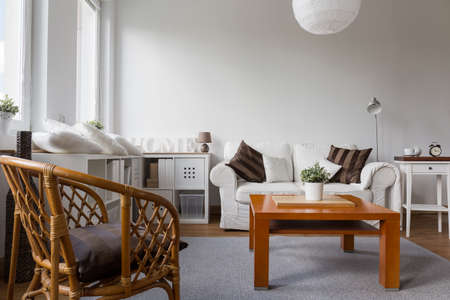 Wicker armchair in white stylish living roomの写真素材