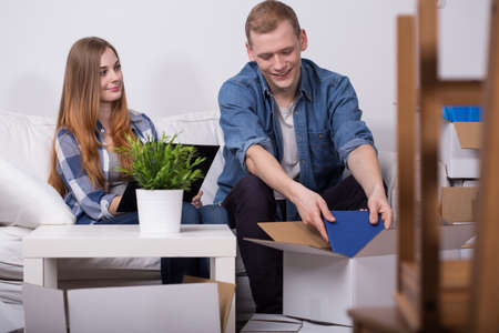 Young woman checking list of things to pack