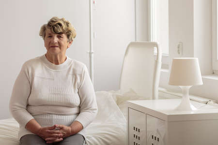 Aged woman in hospital waiting for treatmentの写真素材