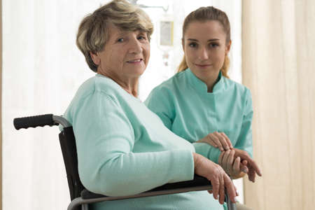 Photo of nurse caring about senior lady with walking problemsの写真素材