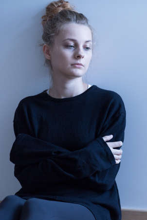 Sad young girl thinking about life in solitude