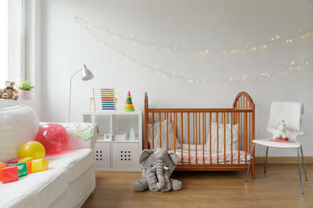 Photo of white and cosy newborn room interiorの写真素材
