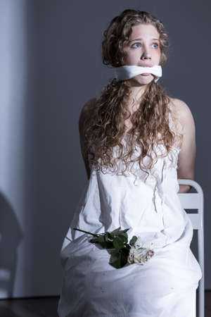 Young victim of rape with gagged mouthの写真素材