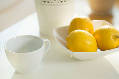 Close up of cup and lemons on the tableの写真素材