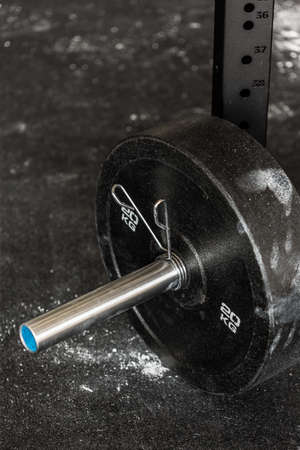 Close-up of barbell plate on the floor