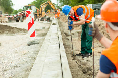 Tired road construction worker building new street