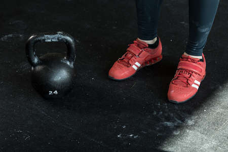 Horizontal view of kettlebell and sporty shoes