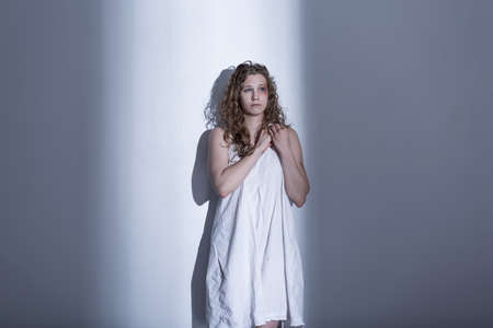 Victim of sexual violence in white dress