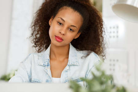 Photo of bethinking businesswoman sitting at laptop at workの写真素材