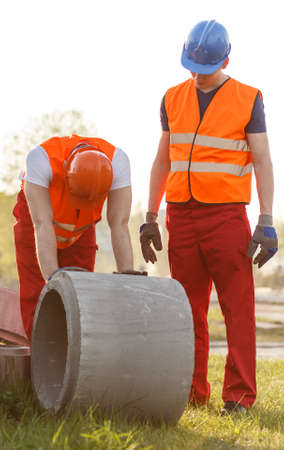 Image of tired construction workers working outdoorの写真素材