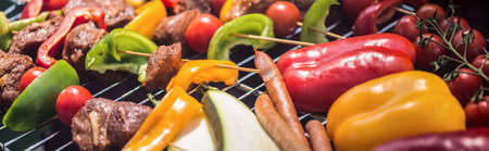 Panorama of colorful grilled vegetables and meat for garden partyの写真素材
