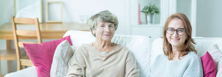 Elder lady with carer sitting on a couch